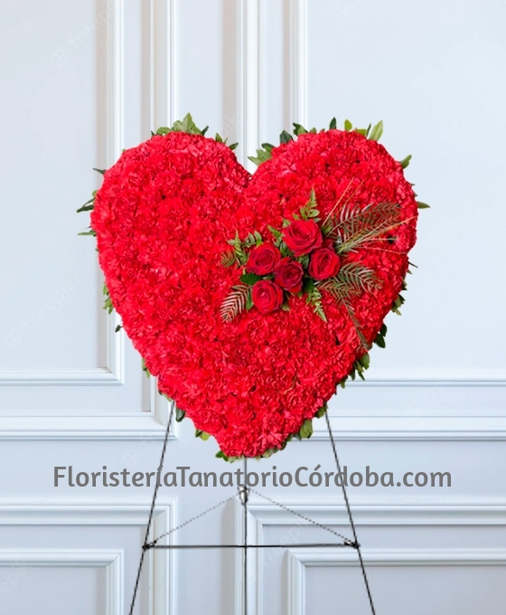 Corazón de flores funerarias rojas